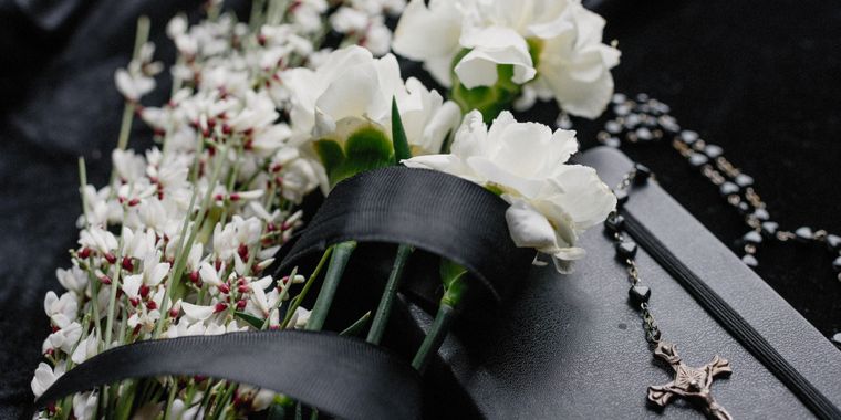White flowers and a rosary in remembrance