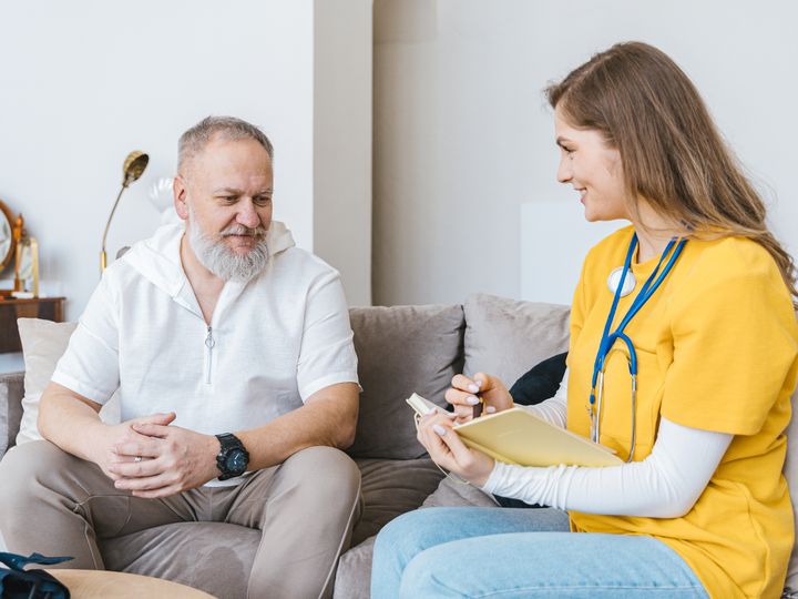 Nurse visiting an older man at home