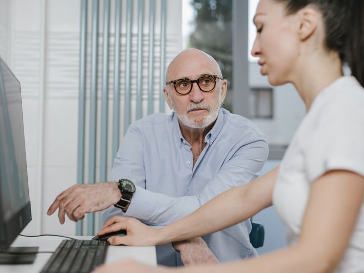 Older patient reviewing results with a health professional