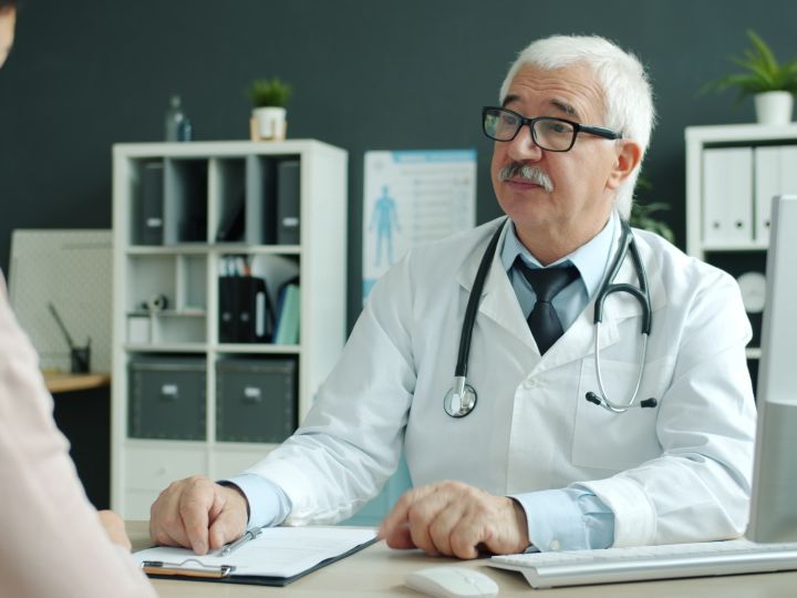 Doctor seeing a patient in his office