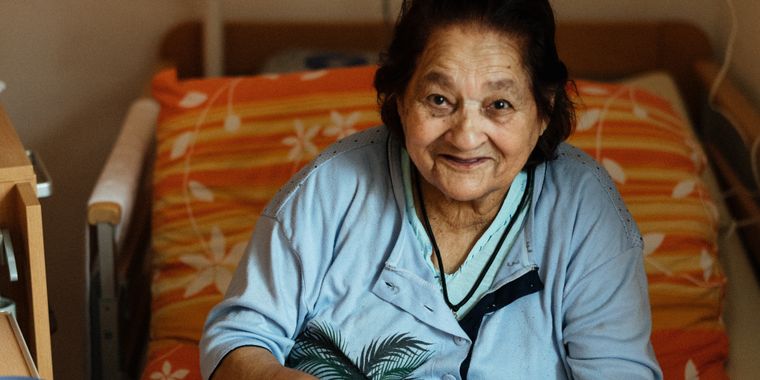 Older woman smiling in her hospital bed