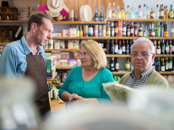 Older couple talking with an advisor in a store