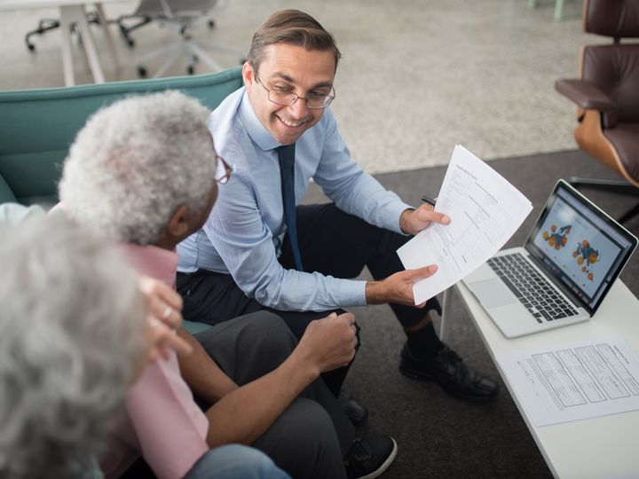Agent explaining documents to older clients