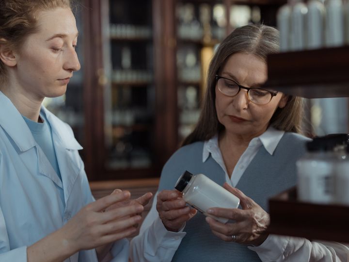Advisor explaining a product to a customer at the pharmacy