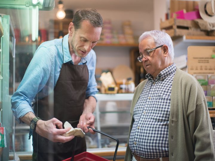 Advisor helping an older man in a store